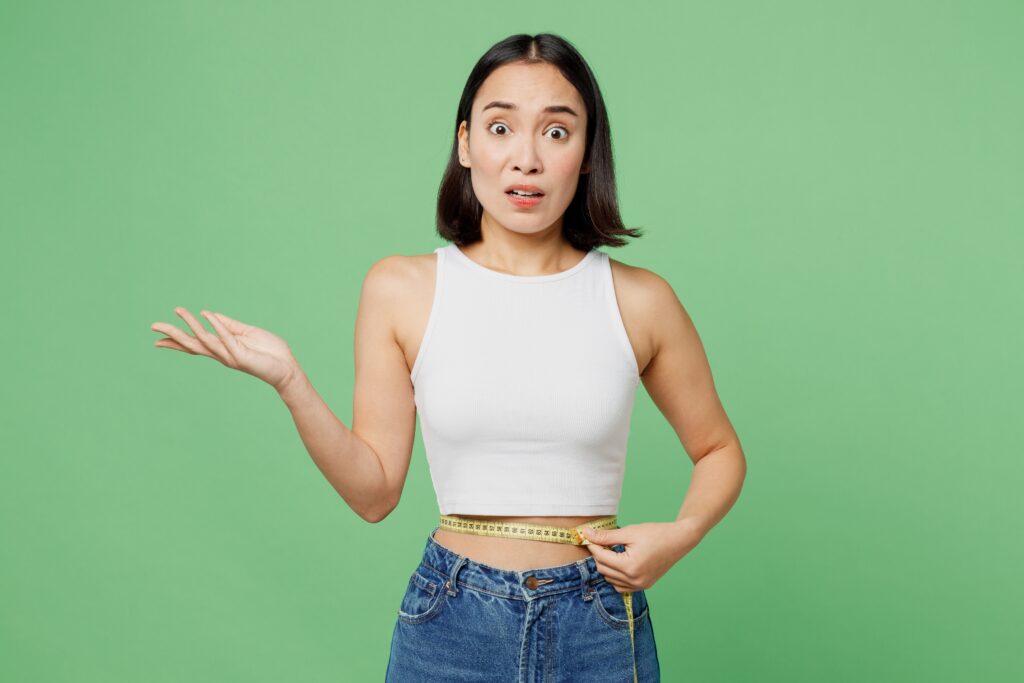 woman with measurement tape around her waist